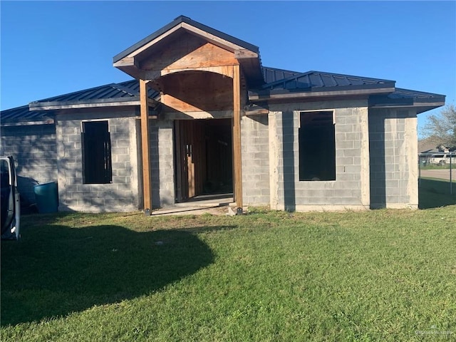 rear view of house with a yard