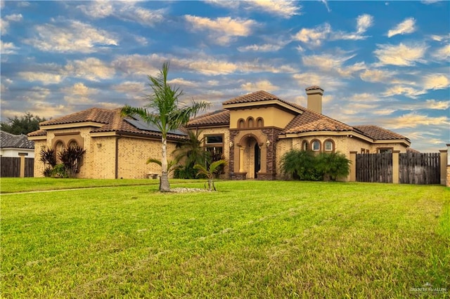 mediterranean / spanish house with a front yard