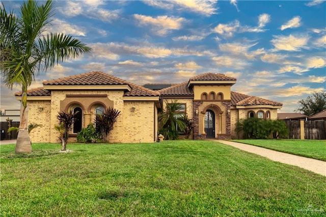 mediterranean / spanish-style house with a front yard