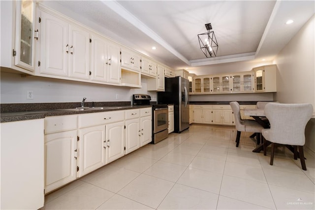 kitchen featuring a raised ceiling, light tile patterned floors, sink, and appliances with stainless steel finishes