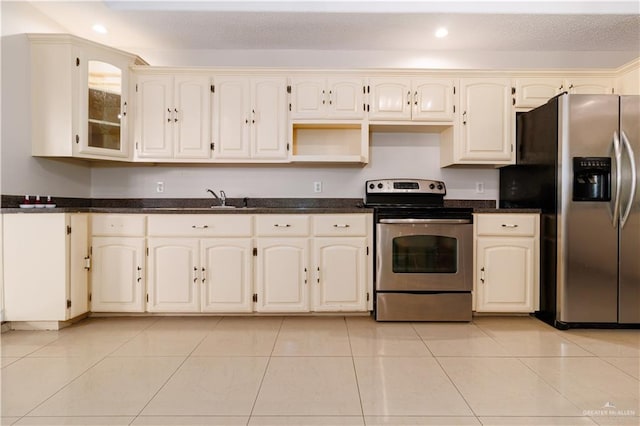 kitchen with light tile patterned floors and stainless steel appliances