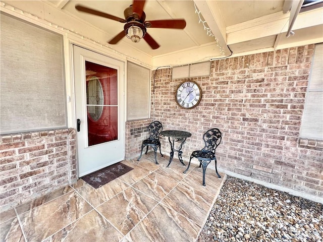 view of exterior entry featuring ceiling fan