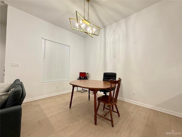 dining area featuring a chandelier and light hardwood / wood-style flooring