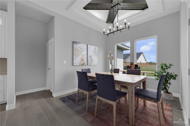 1104 Azalea Ave, Mission, TX 78573 - dining area with a chandelier, a tray ceiling, baseboards, and wood finished floors
