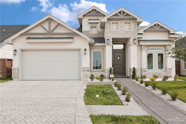 view of front of property with a garage, stucco siding, driveway, and stone siding