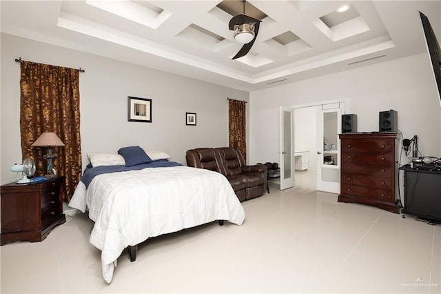 bedroom with a ceiling fan, light tile patterned floors, coffered ceiling, and connected bathroom