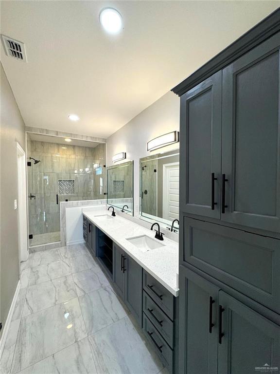 bathroom featuring an enclosed shower and vanity