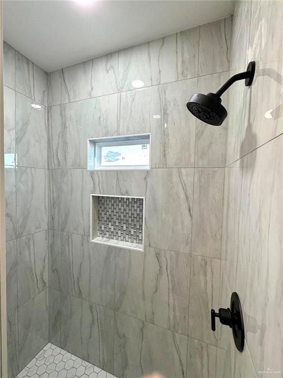 bathroom with a tile shower