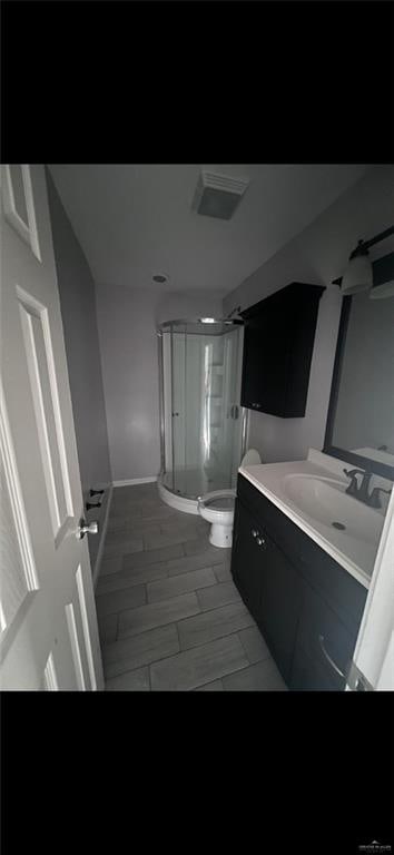 2201 S Jackson Rd Unit J11, Pharr, TX 78577 - full bathroom with visible vents, vanity, a stall shower, and toilet