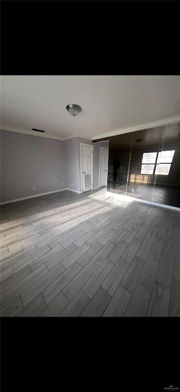 2201 S Jackson Rd Unit J11, Pharr, TX 78577 - spare room featuring baseboards, crown molding, visible vents, and wood tiled floor