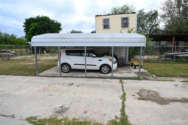 view of parking / parking lot featuring a yard and a carport