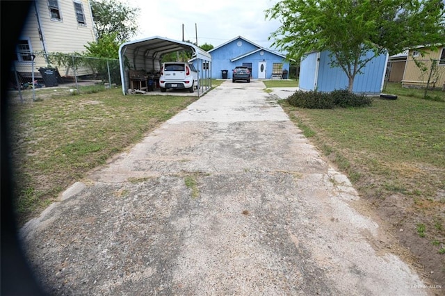 exterior space featuring a carport and a front yard