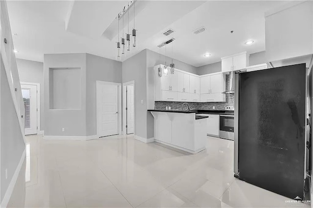 kitchen featuring backsplash, fridge, decorative light fixtures, stainless steel range with electric stovetop, and white cabinets