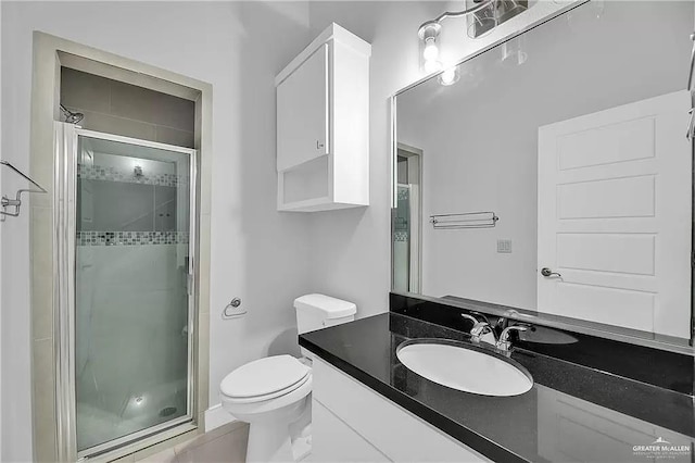 bathroom with vanity, toilet, and walk in shower