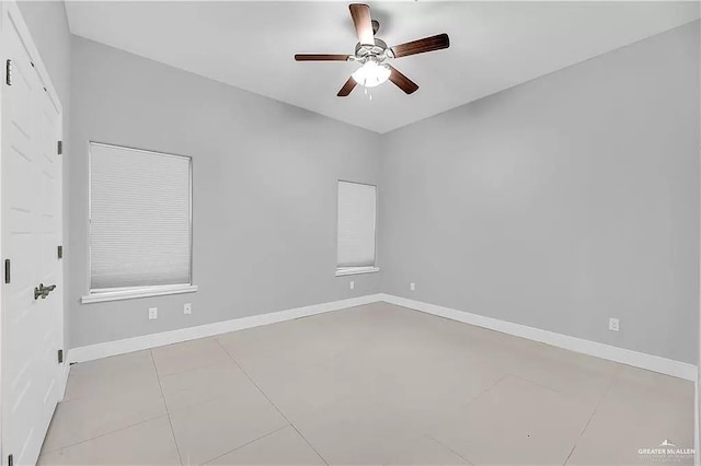 tiled empty room featuring ceiling fan