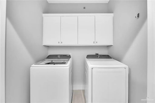 laundry room featuring cabinets and separate washer and dryer