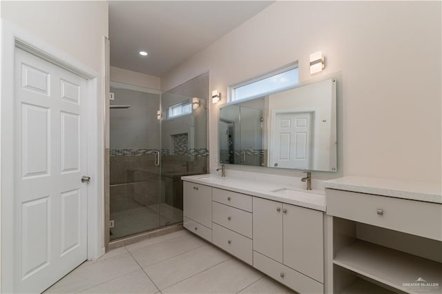 bathroom with tile patterned floors, vanity, and an enclosed shower