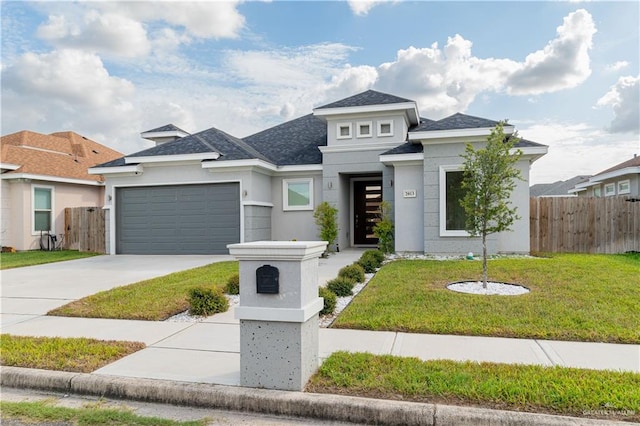 view of front facade with a garage and a front lawn