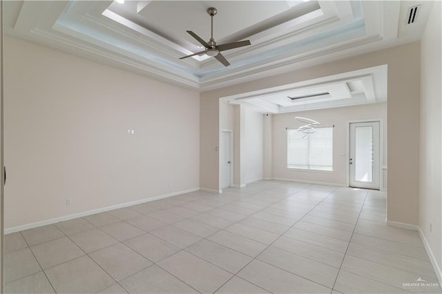 spare room with light tile patterned floors, a raised ceiling, and ceiling fan