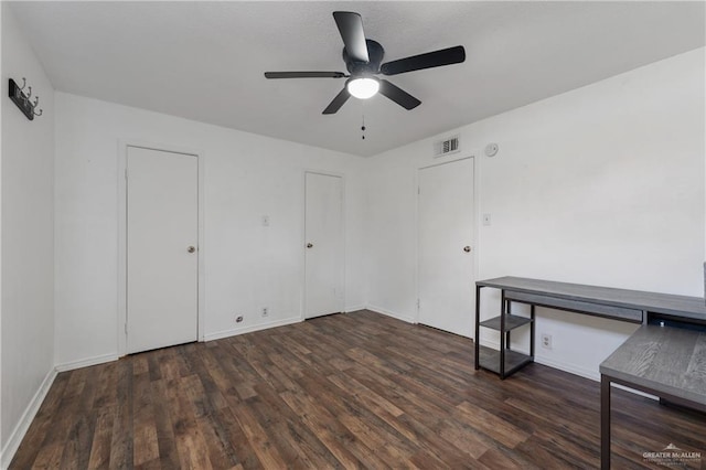 unfurnished room with ceiling fan and dark hardwood / wood-style flooring