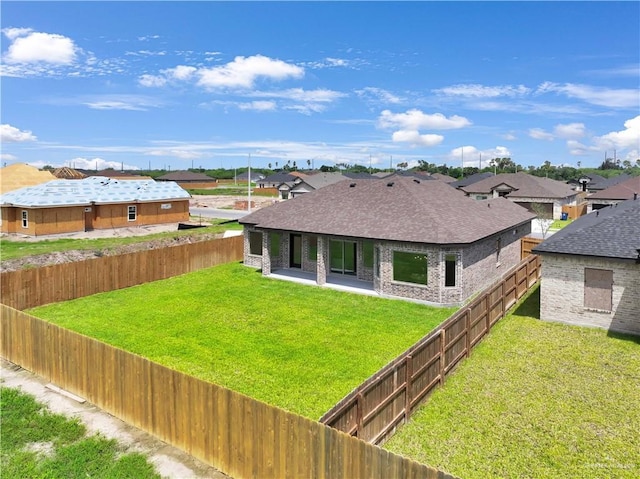 1502 Stirrup Cir, San Benito, TX 78586 - back of property featuring a shingled roof, a fenced backyard, a patio, and a residential view