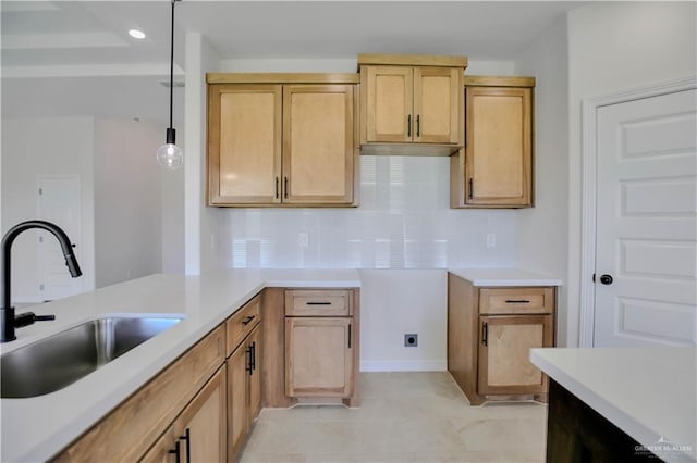 1502 Stirrup Cir, San Benito, TX 78586 - kitchen with a sink, backsplash, light countertops, decorative light fixtures, and light tile patterned floors
