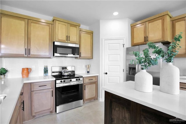 1502 Stirrup Cir, San Benito, TX 78586 - kitchen featuring stainless steel appliances, backsplash, light countertops, and recessed lighting