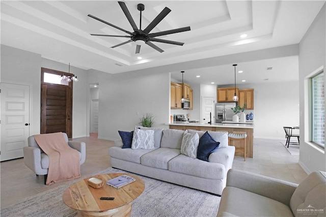 1502 Stirrup Cir, San Benito, TX 78586 - living area with a raised ceiling, recessed lighting, light tile patterned floors, and ceiling fan