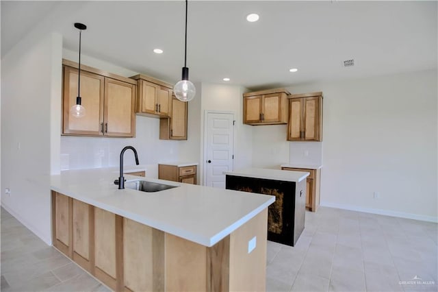 1502 Stirrup Cir, San Benito, TX 78586 - kitchen with a sink, a peninsula, recessed lighting, hanging light fixtures, and baseboards