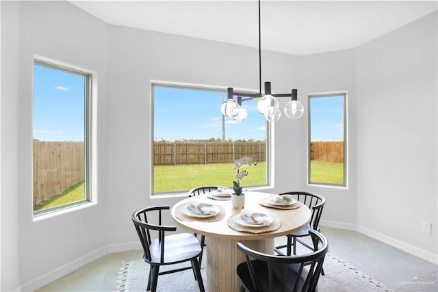 1502 Stirrup Cir, San Benito, TX 78586 - dining space featuring a chandelier, plenty of natural light, and light tile patterned flooring
