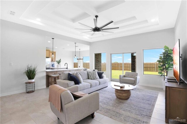 1502 Stirrup Cir, San Benito, TX 78586 - living room featuring a raised ceiling, a ceiling fan, recessed lighting, and coffered ceiling
