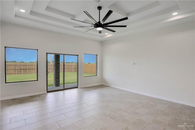 1502 Stirrup Cir, San Benito, TX 78586 - spare room featuring a tray ceiling, recessed lighting, ceiling fan, and baseboards
