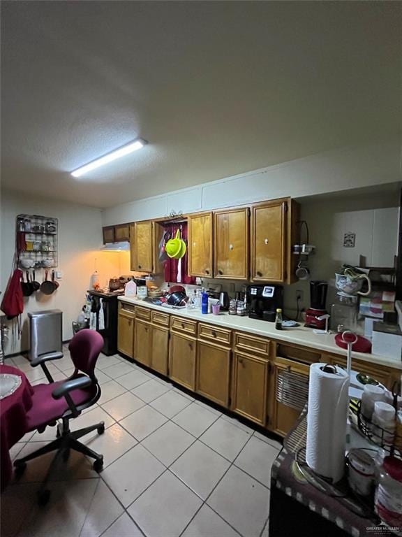 kitchen featuring light tile patterned floors and electric stove