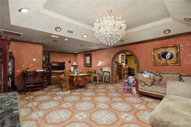 living room featuring a raised ceiling and a notable chandelier