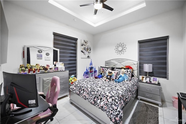1613 E Mayhem Dr, Edinburg, TX 78542 - bedroom featuring light marble finish floors, a raised ceiling, and ceiling fan