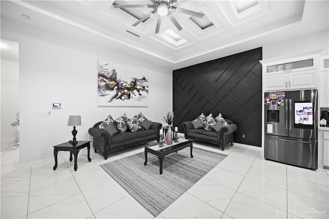 1613 E Mayhem Dr, Edinburg, TX 78542 - living area featuring light marble finish floors, an accent wall, a raised ceiling, a ceiling fan, and baseboards