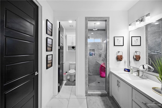 1613 E Mayhem Dr, Edinburg, TX 78542 - full bathroom with a stall shower, double vanity, marble look tile flooring, and toilet