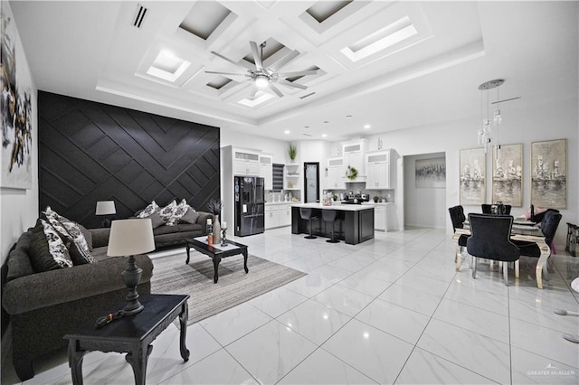 1613 E Mayhem Dr, Edinburg, TX 78542 - living room with a ceiling fan, light marble finish flooring, recessed lighting, an accent wall, and coffered ceiling