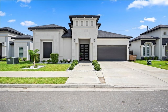 1613 E Mayhem Dr, Edinburg, TX 78542 - view of front of property with a garage, driveway, a front lawn, french doors, and stucco siding