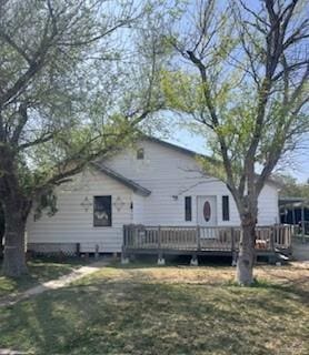 back of property with a wooden deck and a yard