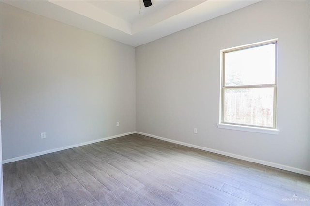 unfurnished room featuring hardwood / wood-style floors and ceiling fan