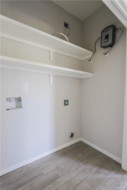 washroom with hardwood / wood-style flooring and hookup for a washing machine