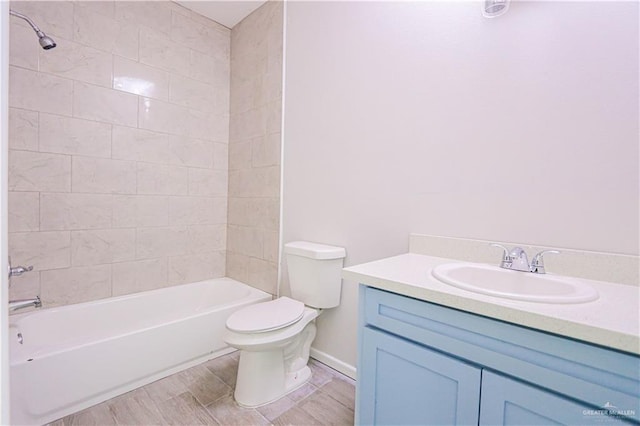 full bathroom featuring vanity, toilet, and tiled shower / bath