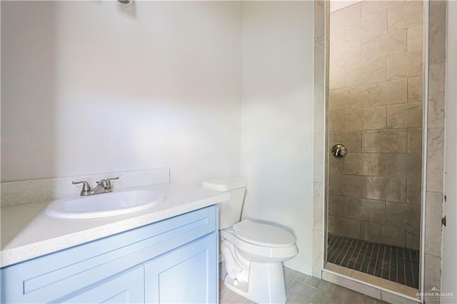 bathroom featuring hardwood / wood-style floors, vanity, toilet, and tiled shower