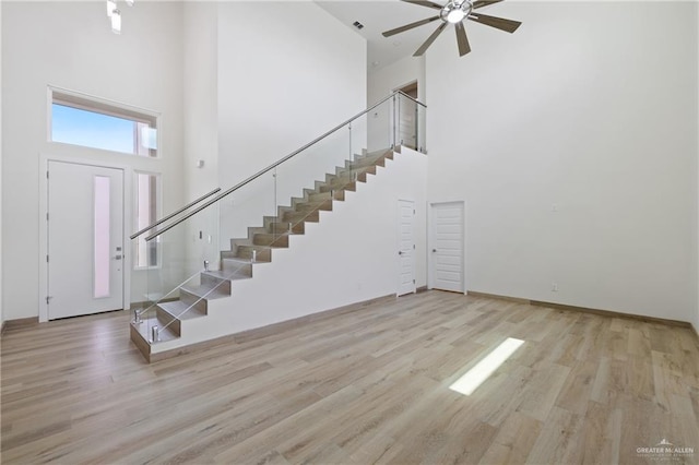 1214 N Lincoln Ave, San Juan, TX 78589 - entryway featuring a high ceiling, stairs, a ceiling fan, wood finished floors, and baseboards