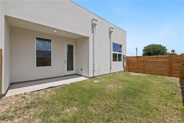 1214 N Lincoln Ave, San Juan, TX 78589 - rear view of property with stucco siding and a patio
