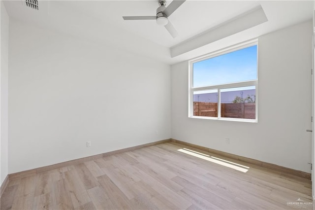 1214 N Lincoln Ave, San Juan, TX 78589 - empty room with wood finished floors, a ceiling fan, baseboards, and a tray ceiling