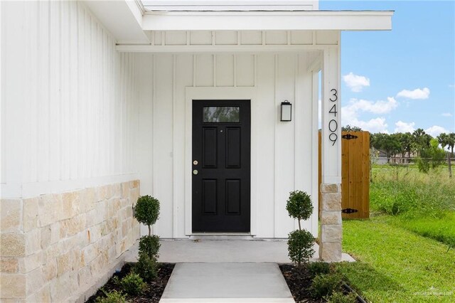 3409 Emma Dr, Weslaco, TX 78596 - doorway to property with board and batten siding