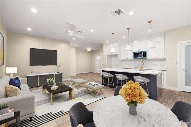 3409 Emma Dr, Weslaco, TX 78596 - living area with recessed lighting, light wood-type flooring, and a ceiling fan