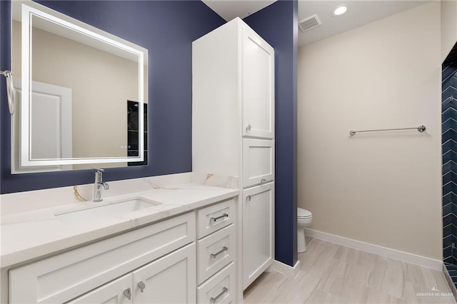 3409 Emma Dr, Weslaco, TX 78596 - bathroom featuring toilet, visible vents, baseboards, vanity, and recessed lighting